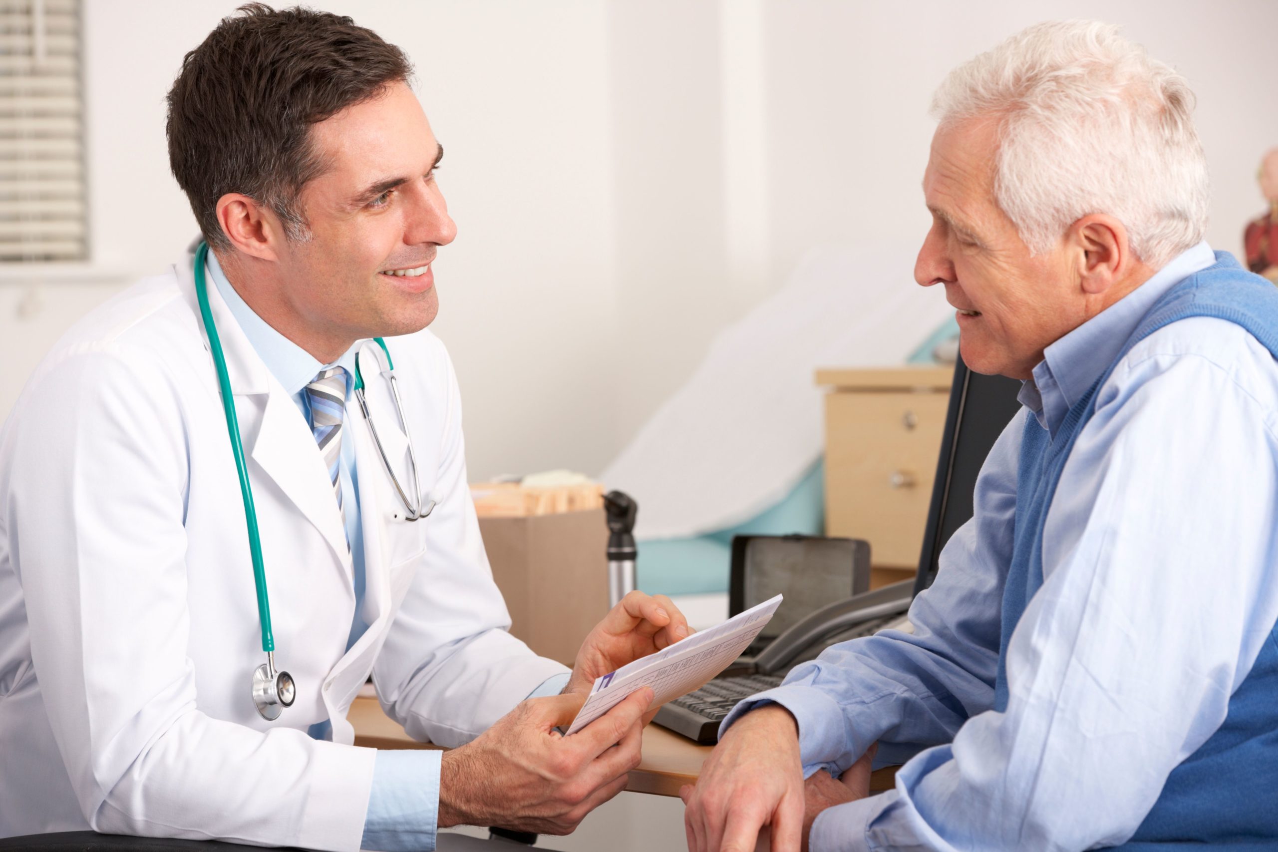 dentist discussing pros and cons of permanent dentures with patient